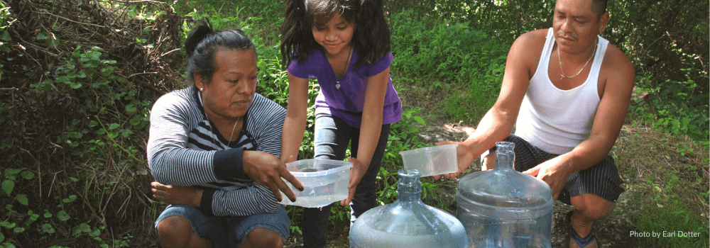 A family collects water outside