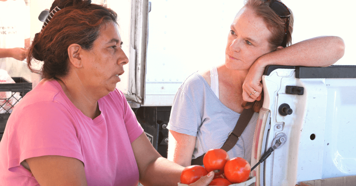 Jillian speaks with woman at farmers market